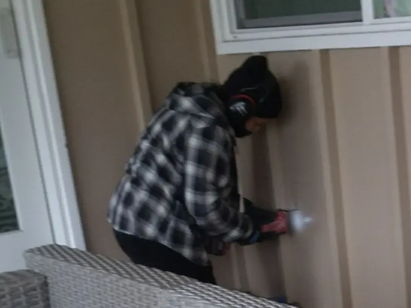 Professional electrician installing an exterior outlet in Luling