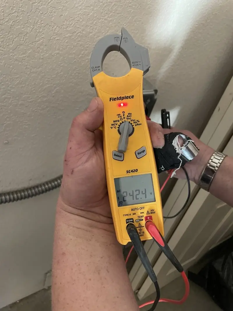 Voltage testing with clamp meter during Recessed Lighting Installation in Luling
